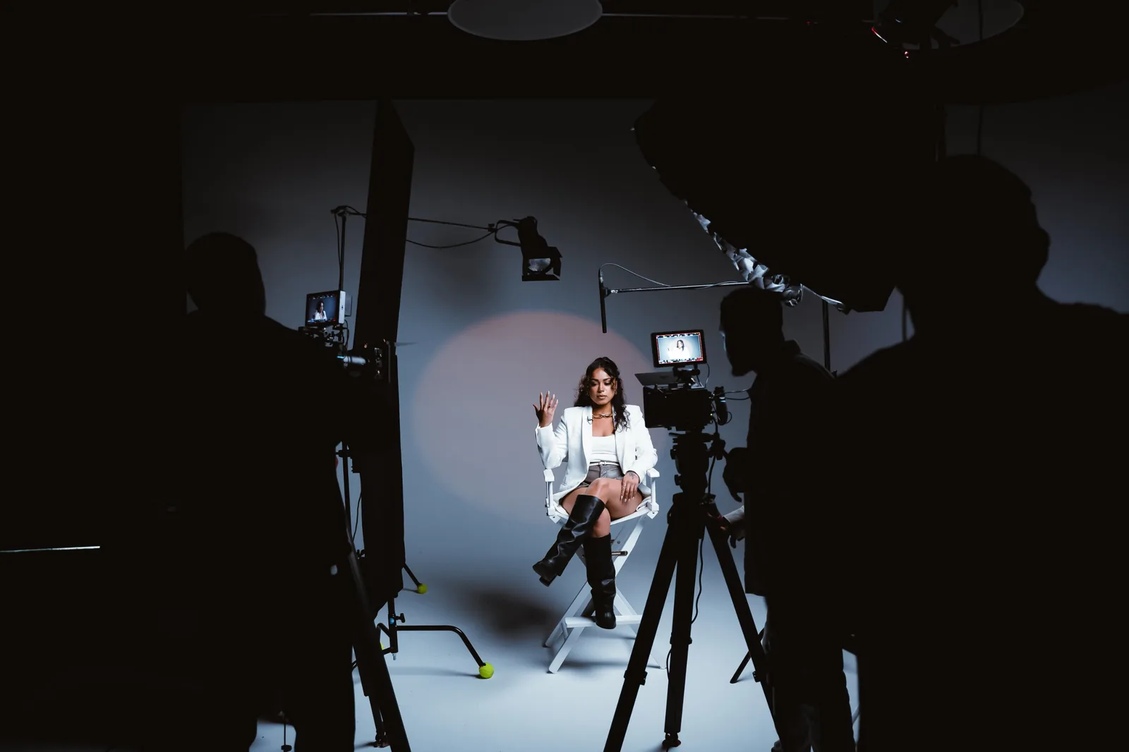 A two-camera interview set by The Sean Signature Collection, the guest lit in a white chair between the crew