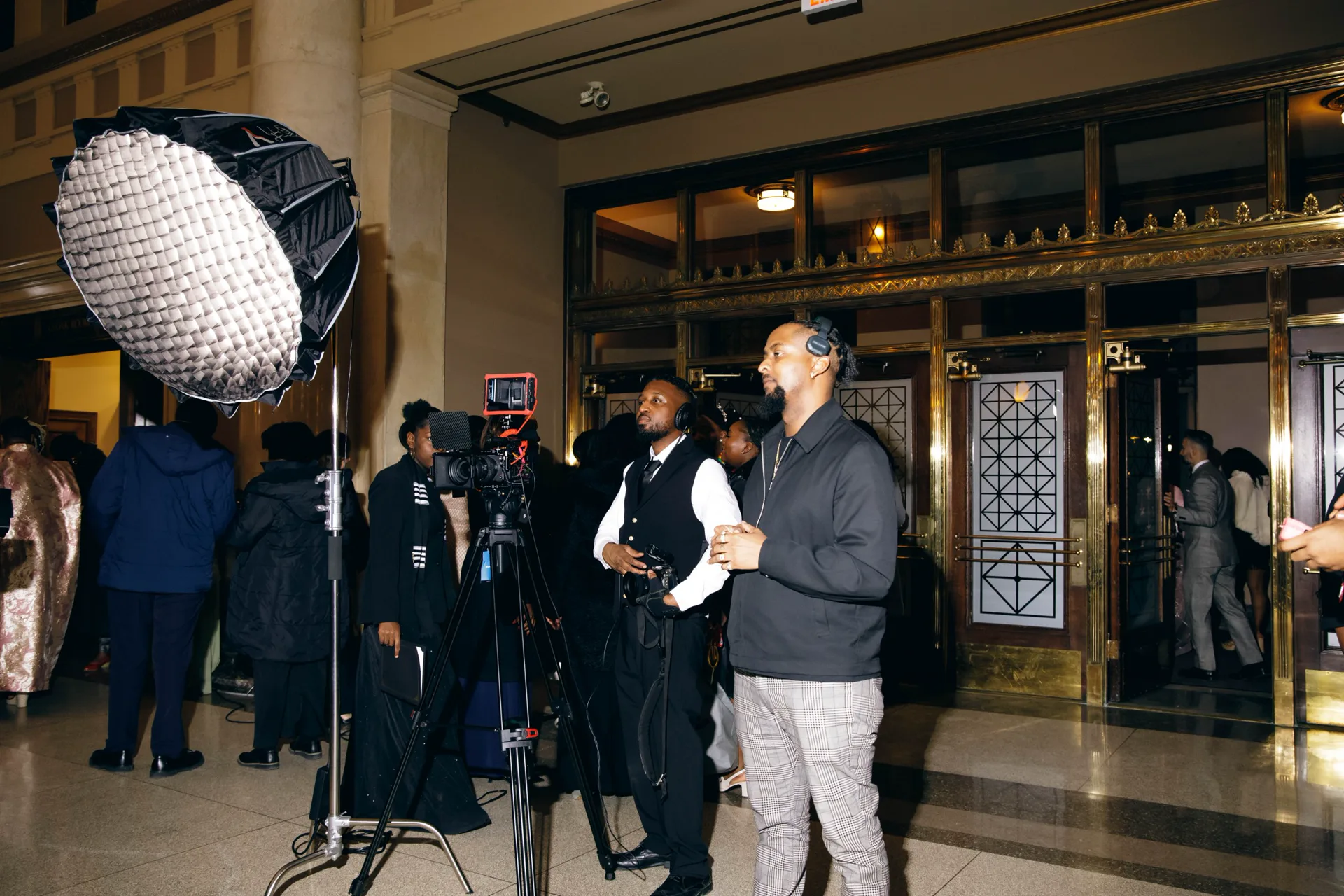 Sean Diamond on camera with the crew in the lobby at the Reverend John C. Holland Awards